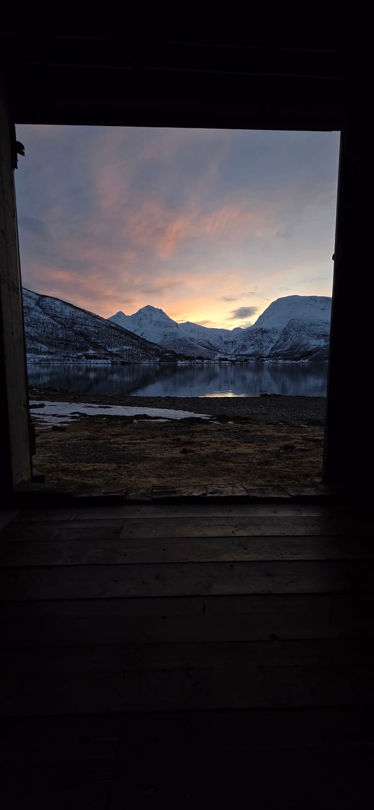 View of the fjord and mountains through the cabin door