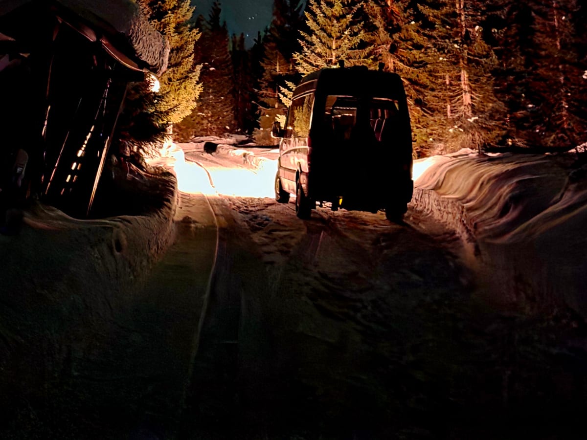 The minibus parked at the basecamp at night