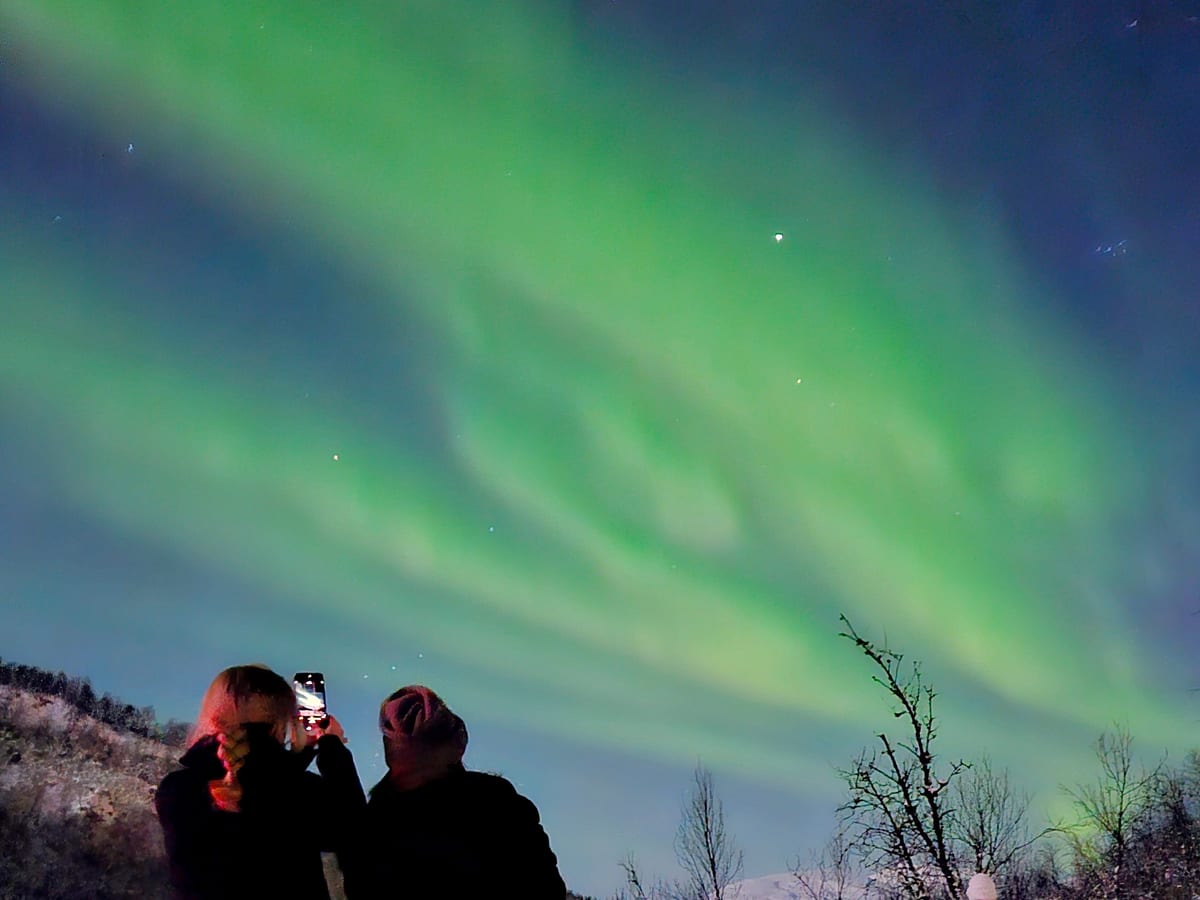 Guests taking photos of the Northern Lights