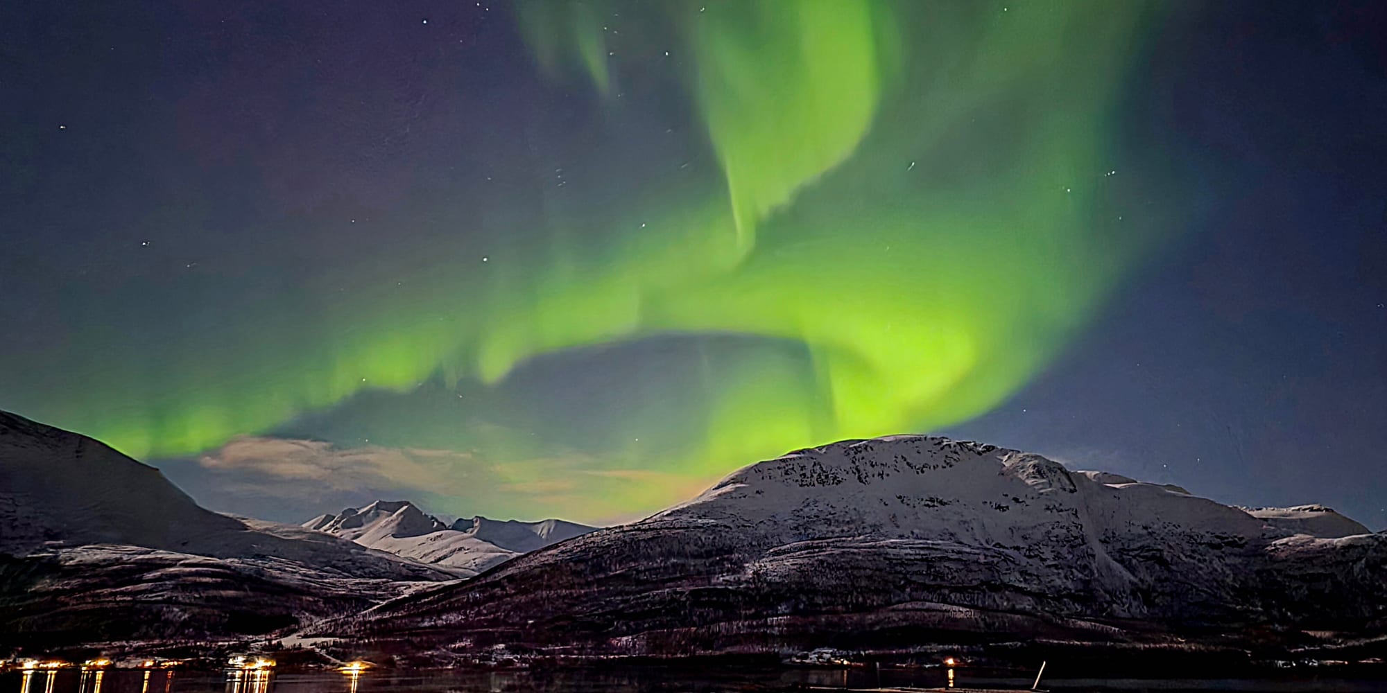 Northern Lights over the fjord and the mountains